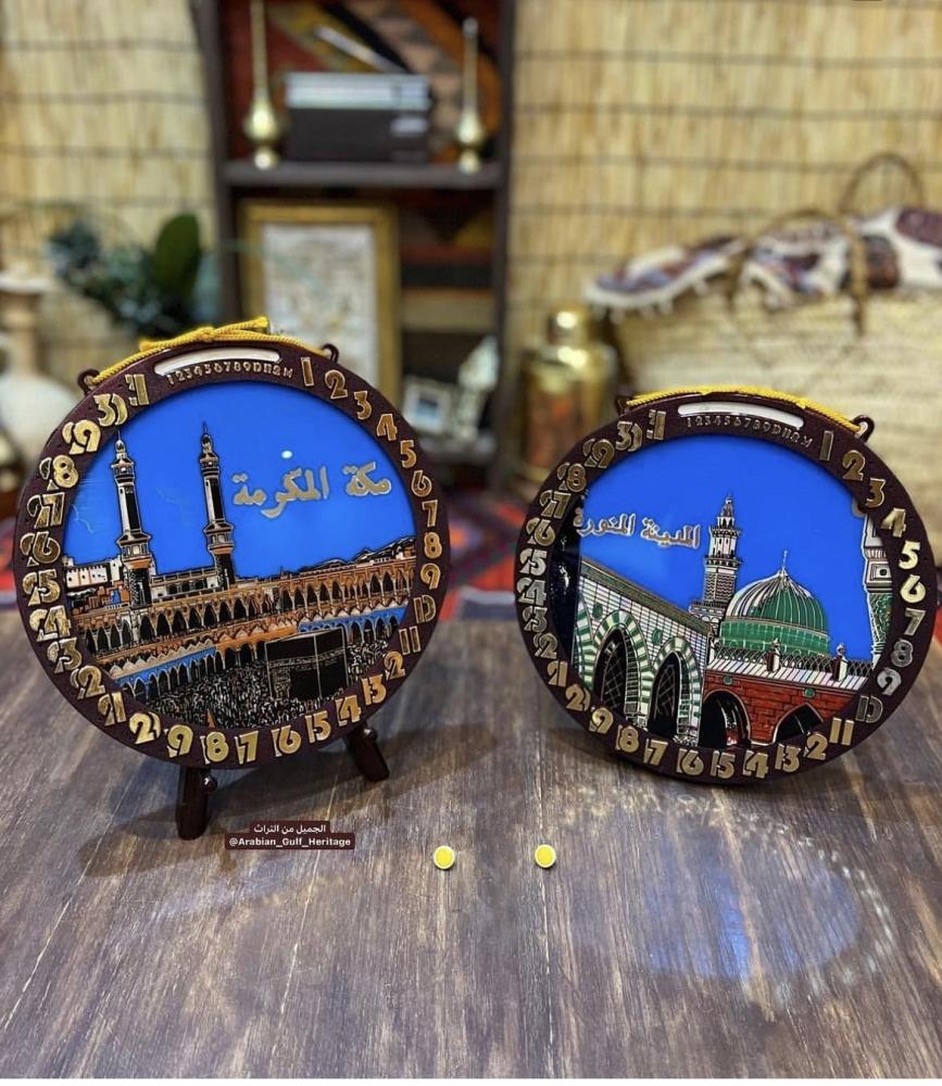 A rare wall hanging with a manual calendar showing months and days, the days are changed with the "yellow pin" visible in the pictures, and inside the calendar, there is a picture of the Masjid al-Haram or the Prophet's Mosque, old stored in cardboard, ma