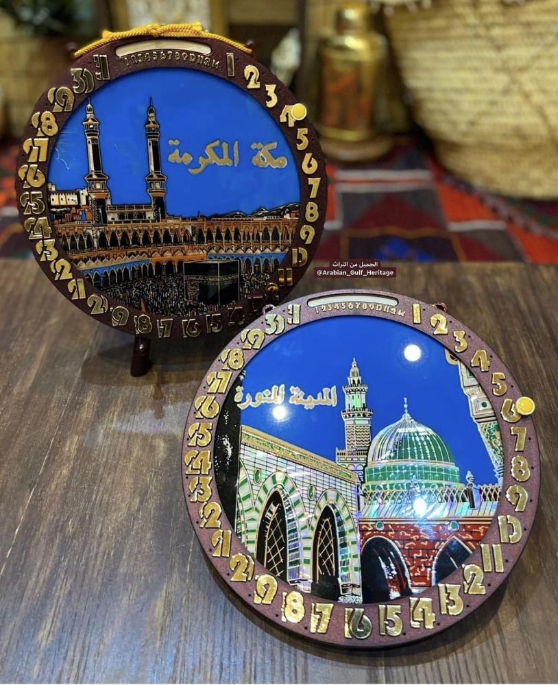 A rare wall hanging with a manual calendar showing months and days, the days are changed with the "yellow pin" visible in the pictures, and inside the calendar, there is a picture of the Masjid al-Haram or the Prophet's Mosque, old stored in cardboard, ma