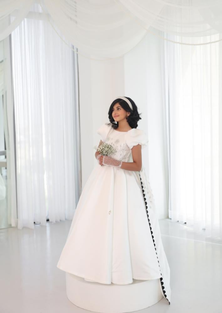 White dress with a back train decorated with sequins and luxurious embroidery