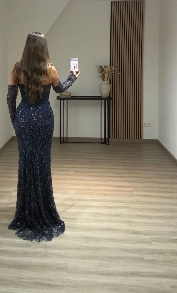 Elegant evening dress, stylish color, fabric, evening look with pleats, and a corset