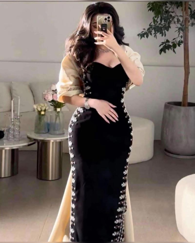 Elegant evening dress adorned with crystals with a stylish train