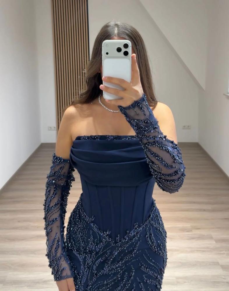 Elegant evening dress, stylish color, fabric, evening look with pleats, and a corset