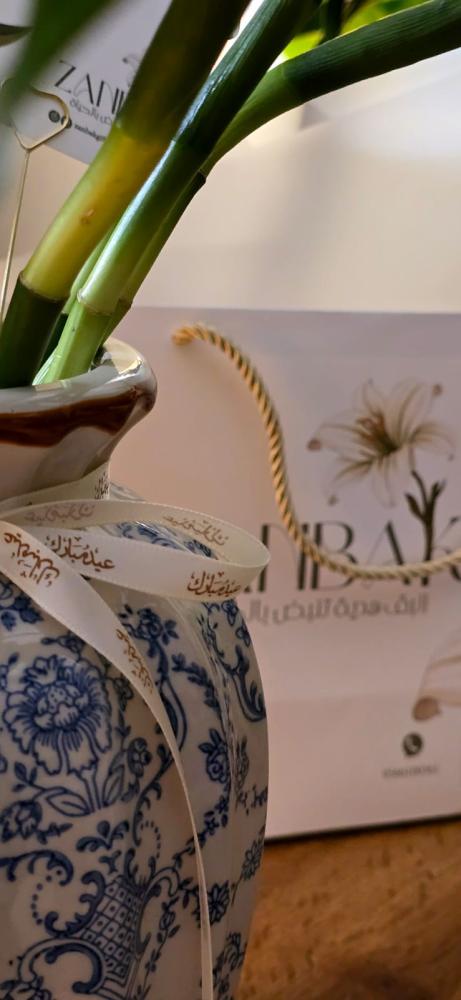Large elegant glass vase with enchanting bamboo plant, gift card, greeting card, and elegant wrapping in a luxurious lily bag