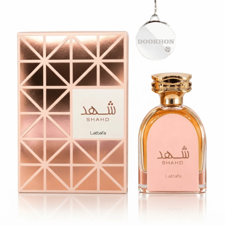 عطر شهد لطافة 100 مل بجانب العلبة الوردية الفاخرة ذات التصميم الهندسي