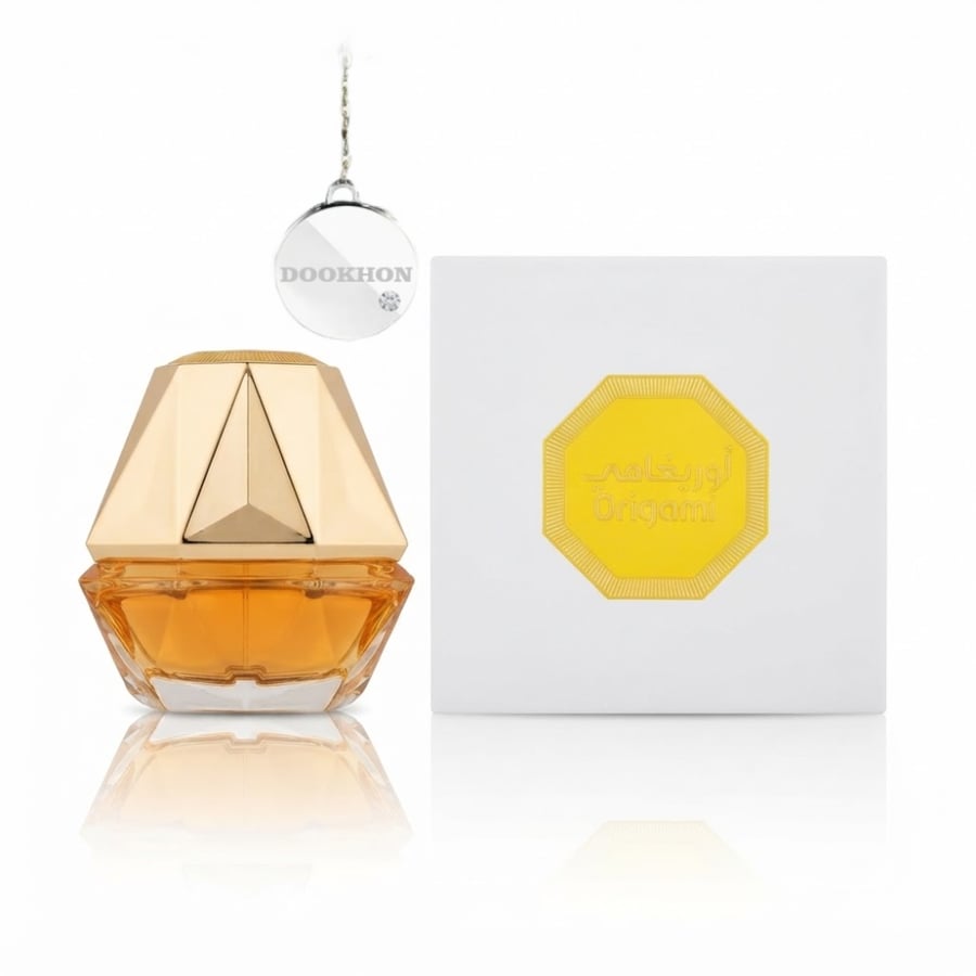 عطر أوريغامي فراجرانس وورلد بجانب العلبة البيضاء والذهبية ذات التصميم