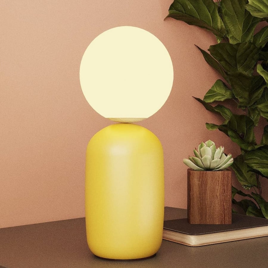 Modern yellow table lamp with a luminous ball