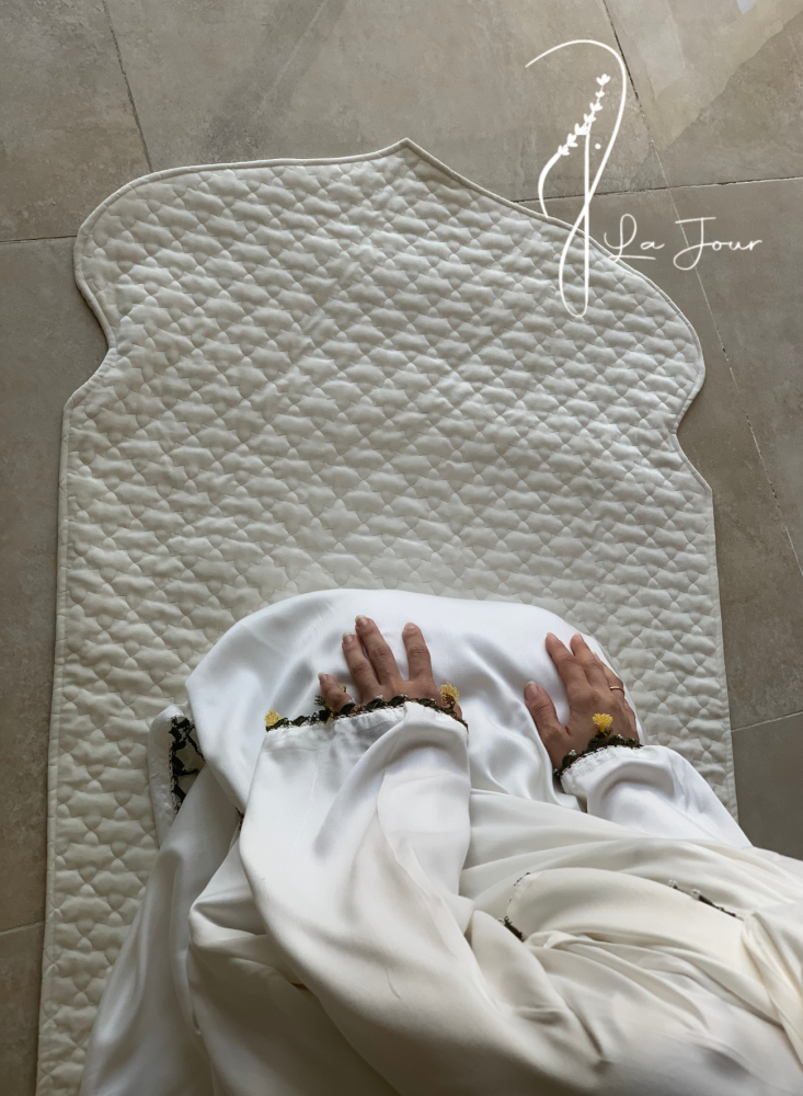 A white wrap-around prayer sheet with crochet and luxurious roses, a veil attached