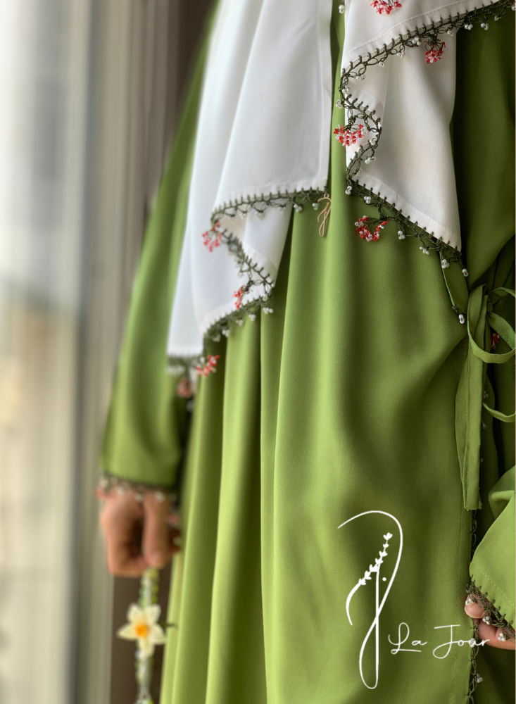 Green prayer shawl decorated with crochet and oya roses
