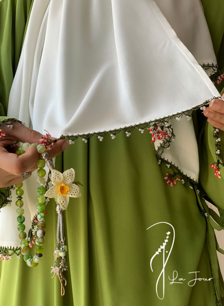 Green prayer shawl decorated with crochet and oya roses
