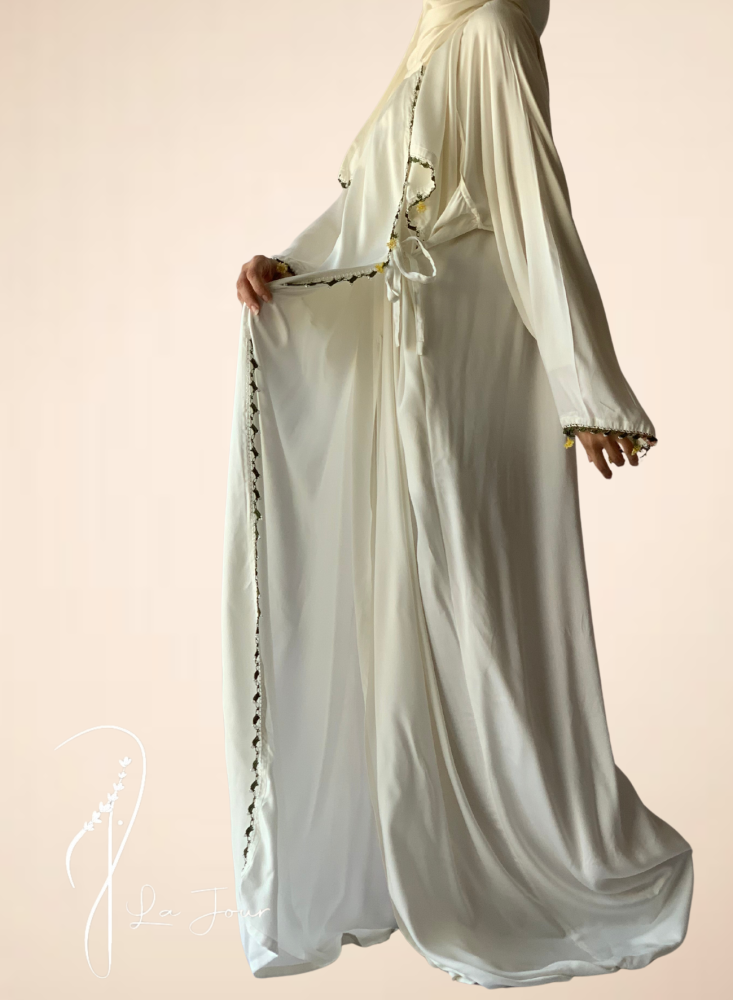 A white wrap-around prayer sheet with crochet and luxurious roses, a veil attached