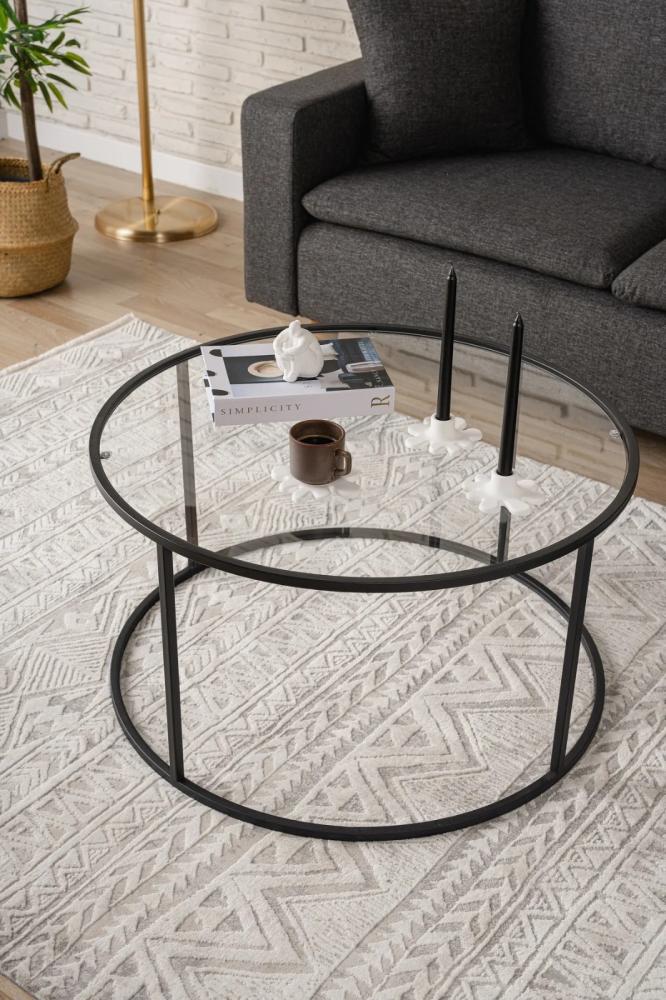 Black iron coffee table with a transparent glass top