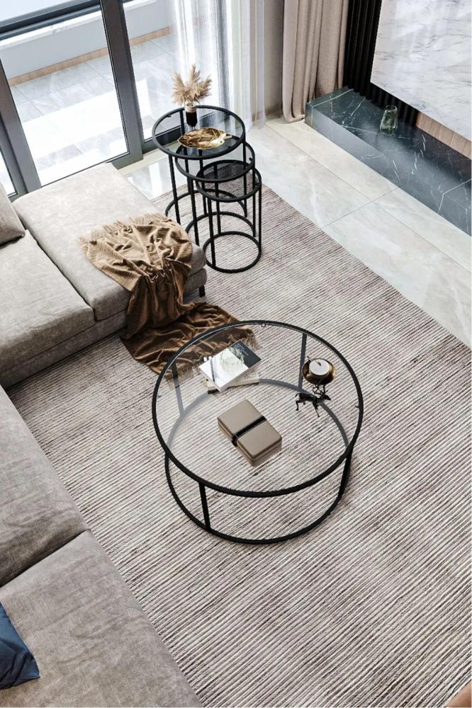 Black iron coffee table with a transparent glass top