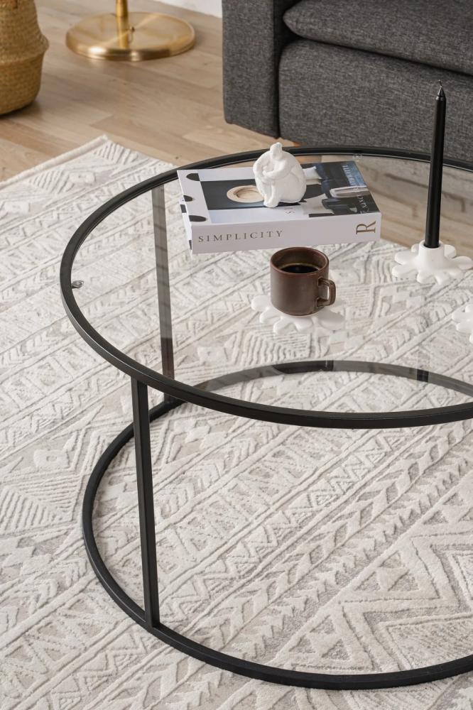 Black iron coffee table with a transparent glass top
