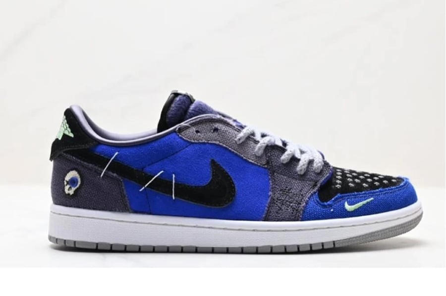 حذاء رجالي نايك رمادي مع ازرق a pair of Nike Air Jordan 1 Retro Low OG Zion Williamson Voodoo Alternate sneakers with canvas and suede material in a mix of blue, grey, black, and white colors