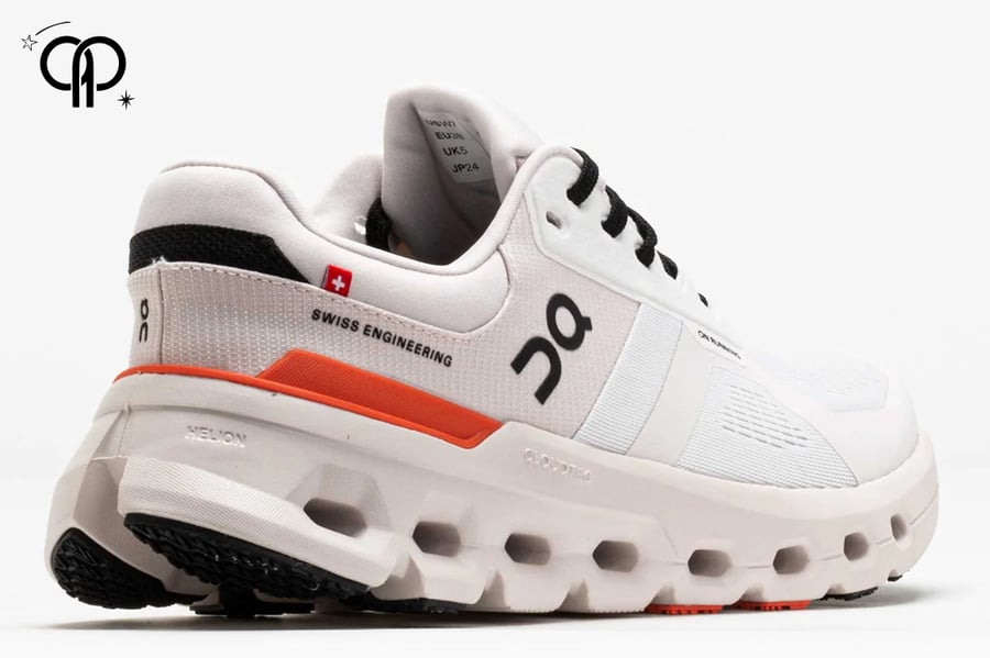 حذاء رجالي اون رانينج كريمي مع اورنج an On Cloudrunner 2 running shoe in the "White & Sand" colorway.