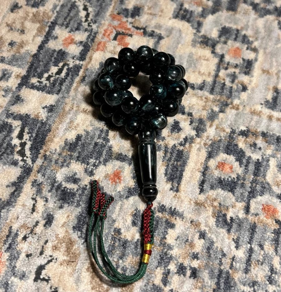 An olive-colored mixed beaded rosary