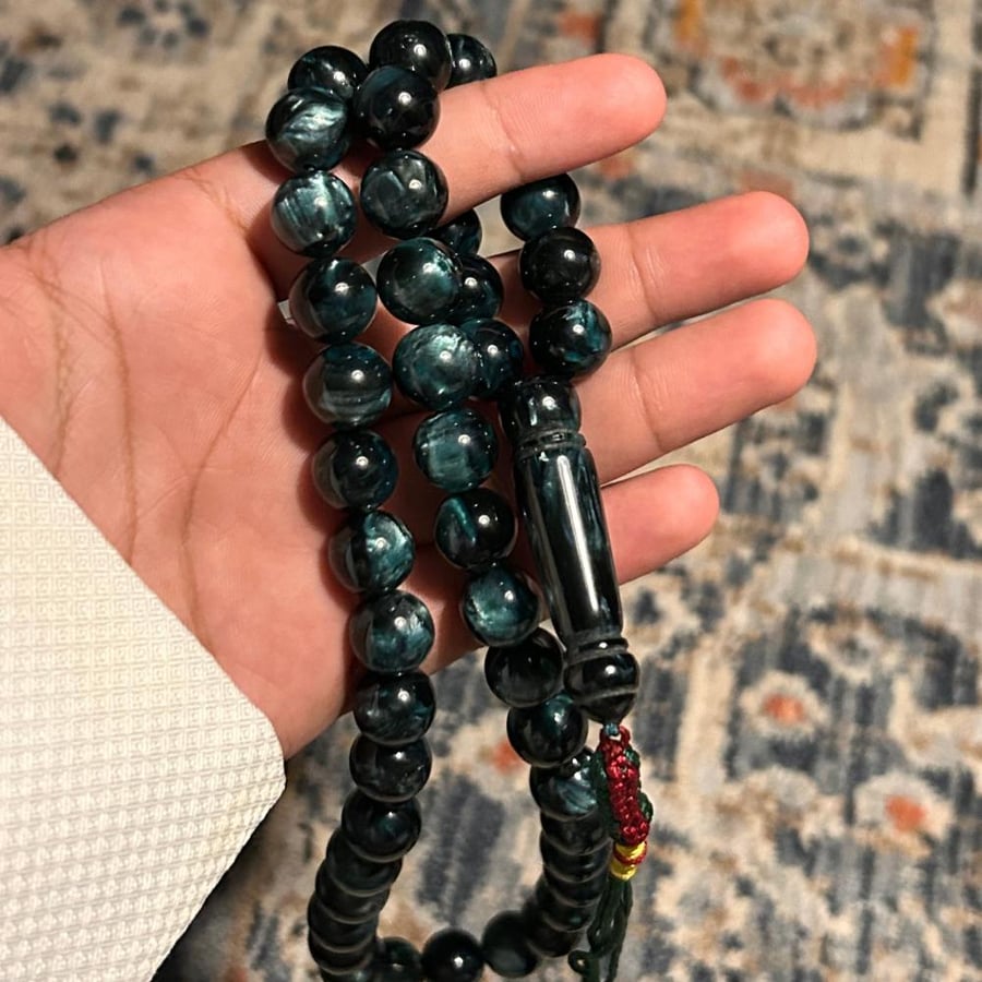 An olive-colored mixed beaded rosary