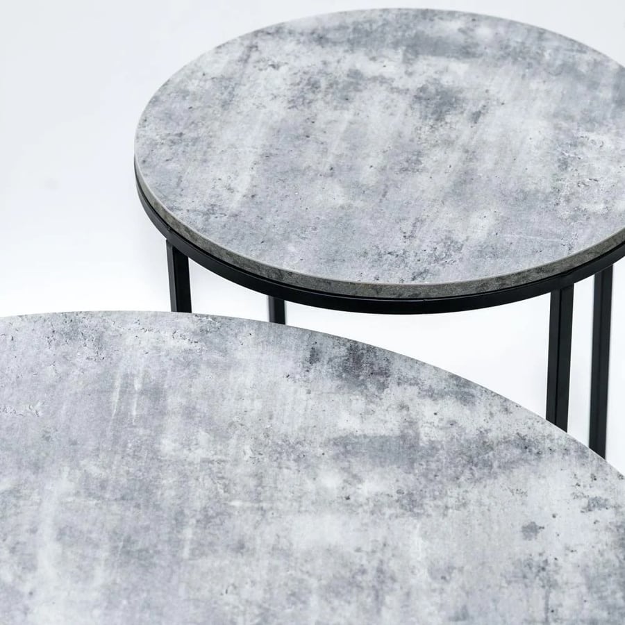 A set of tables made of wood and metal with a distinctive design in gray and black.