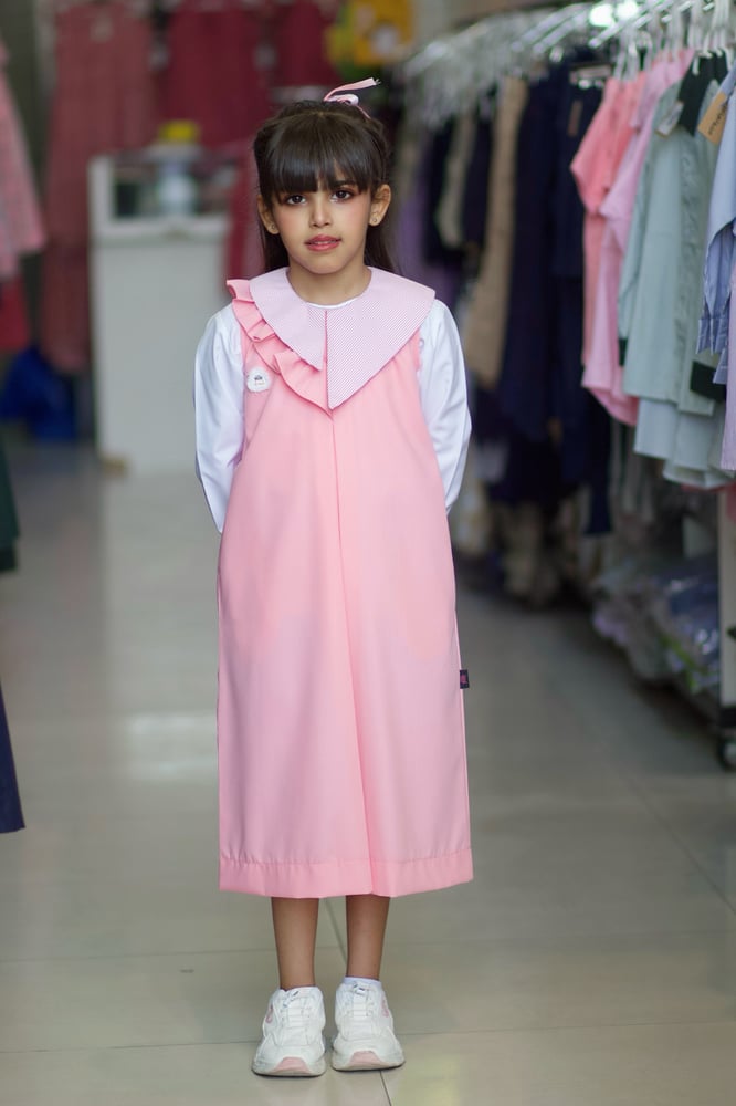 Pink primary apron with ruffle at the neck, medium, reduces 4 inches