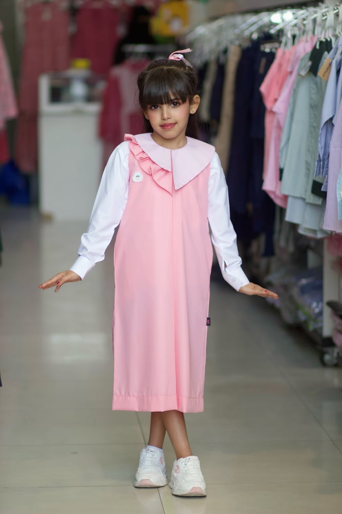 Pink primary apron with ruffle at the neck, medium, reduces 4 inches
