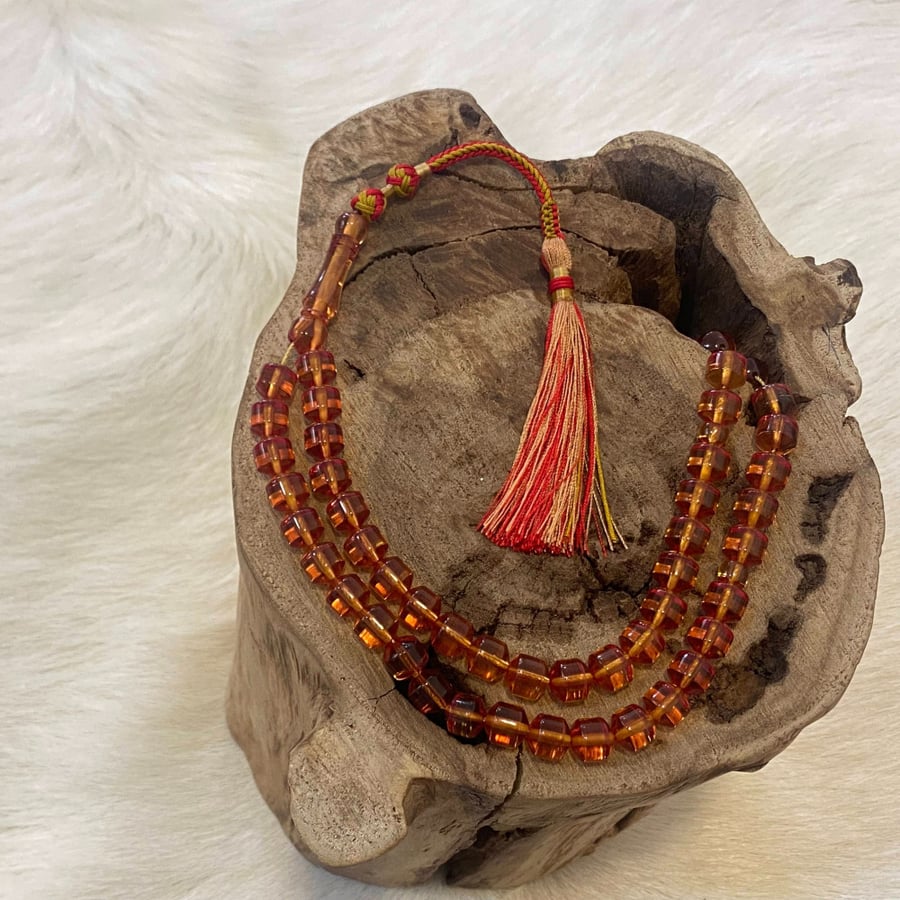 Saffron-colored prayer beads - Gold