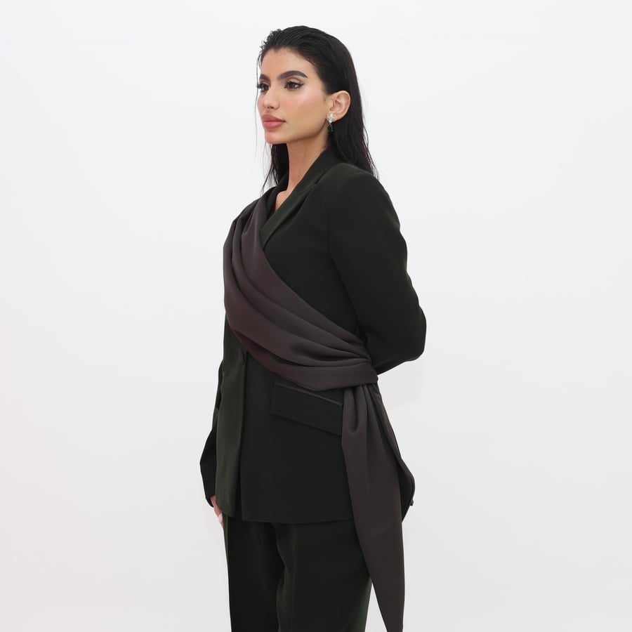 A refined suit set with a satin drape from the shoulder to the waist in deep olive green