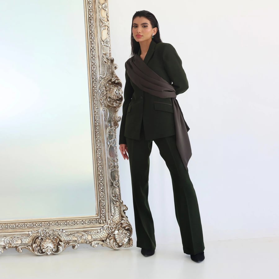 A refined suit set with a satin drape from the shoulder to the waist in deep olive green