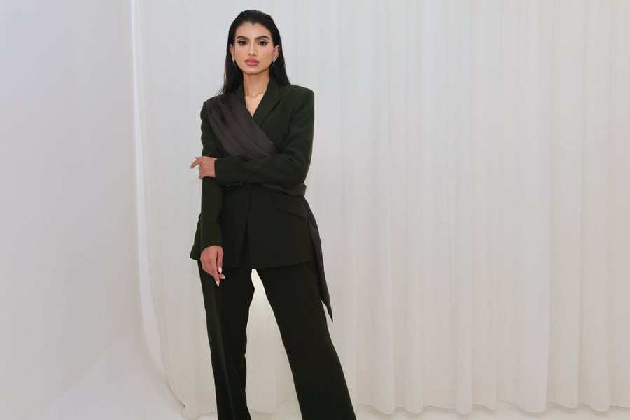 A refined suit set with a satin drape from the shoulder to the waist in deep olive green