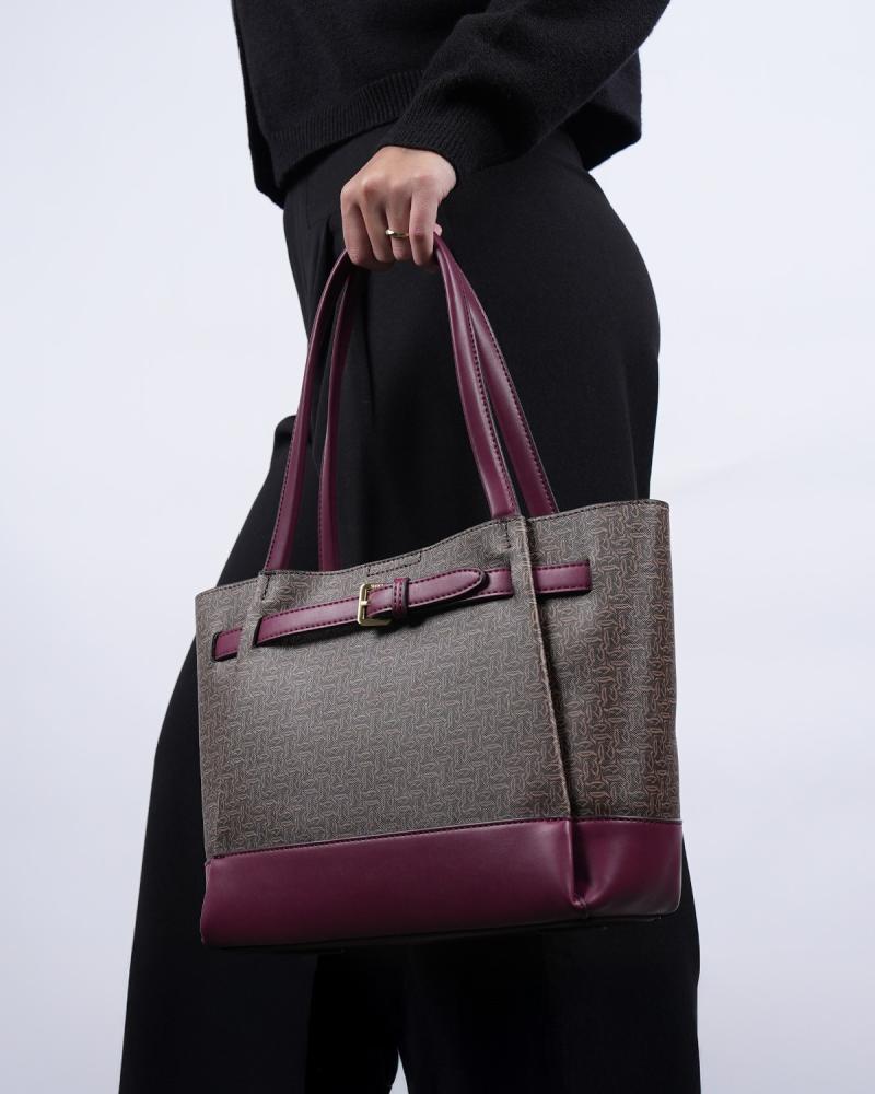 A spacious, practical women's bag in a burgundy color.