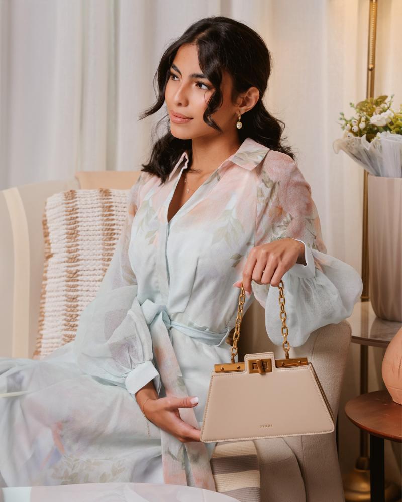 Women's handbag with a modern design in beige color