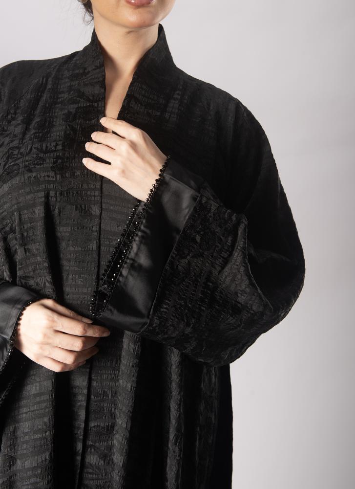 Elegant classic abaya with sleeves decorated with edges