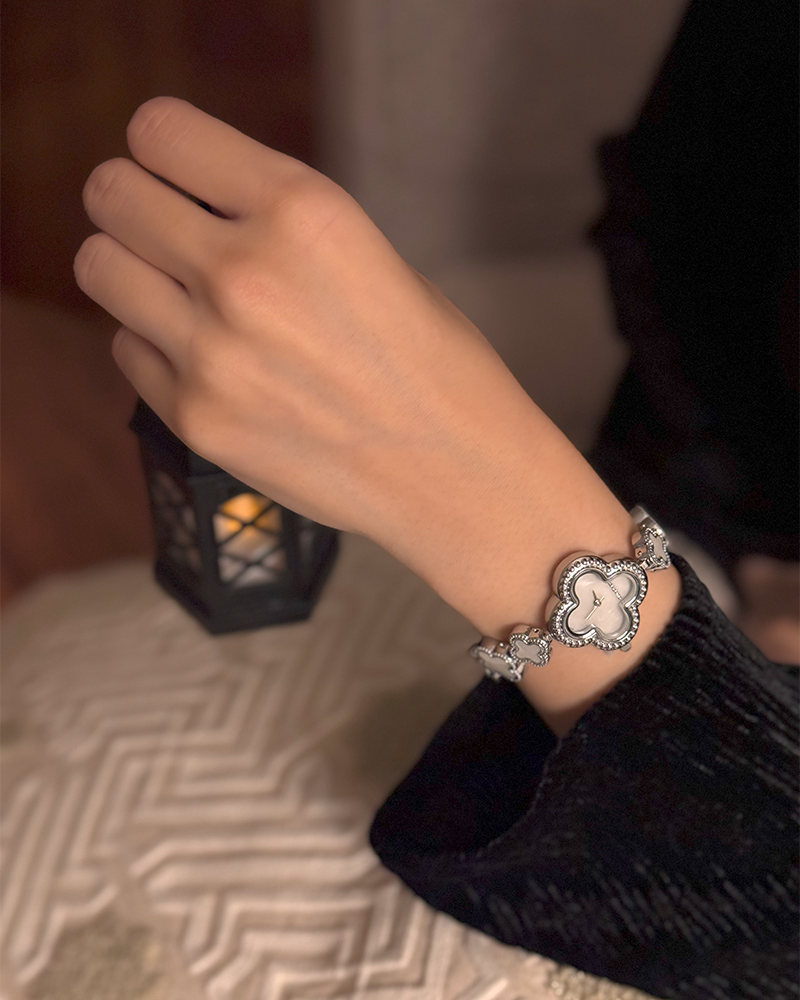 A watch with a calm nod design in silver color with a white dial