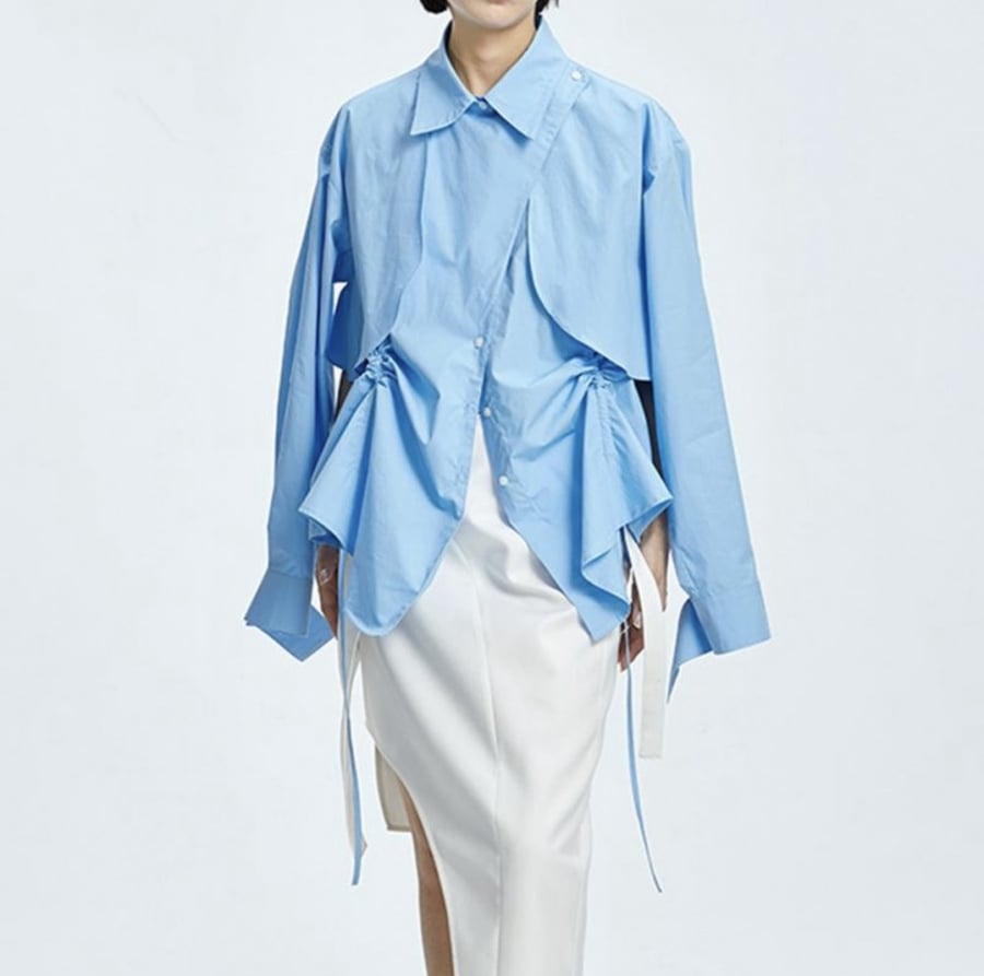 The blouse is available in two colors, white and cyan