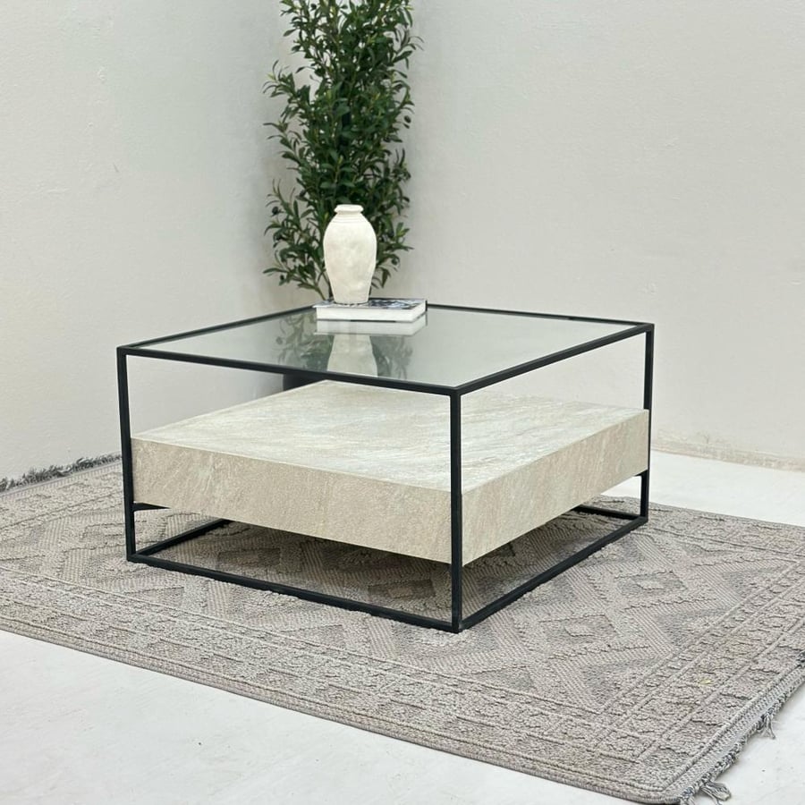Coffee table with a transparent glass surface, half replaced with stone, iron base.