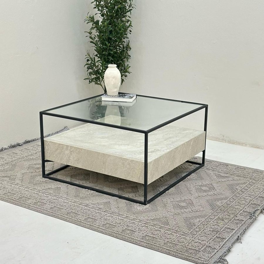 Coffee table with a transparent glass surface, half replaced with stone, iron base.
