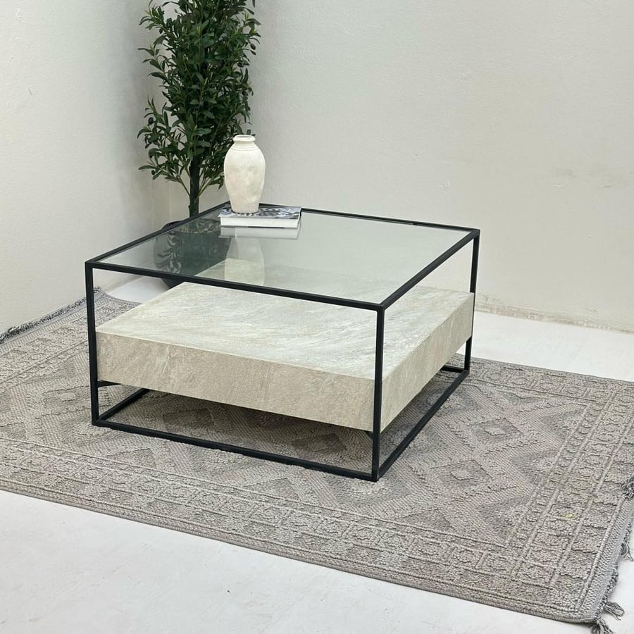 Coffee table with a transparent glass surface, half replaced with stone, iron base.
