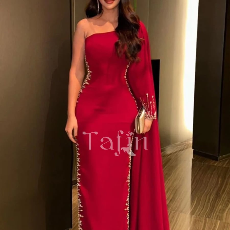A tight dress at the waist and long sleeve on one shoulder embroidered on the sides