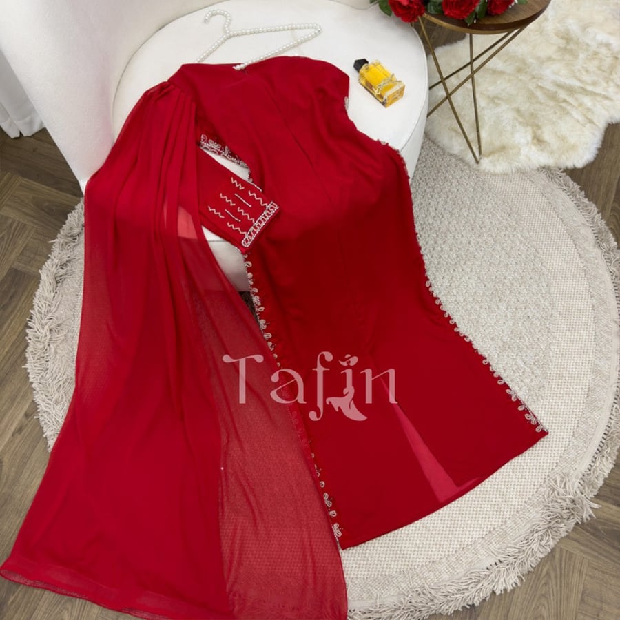 A tight dress at the waist and long sleeve on one shoulder embroidered on the sides