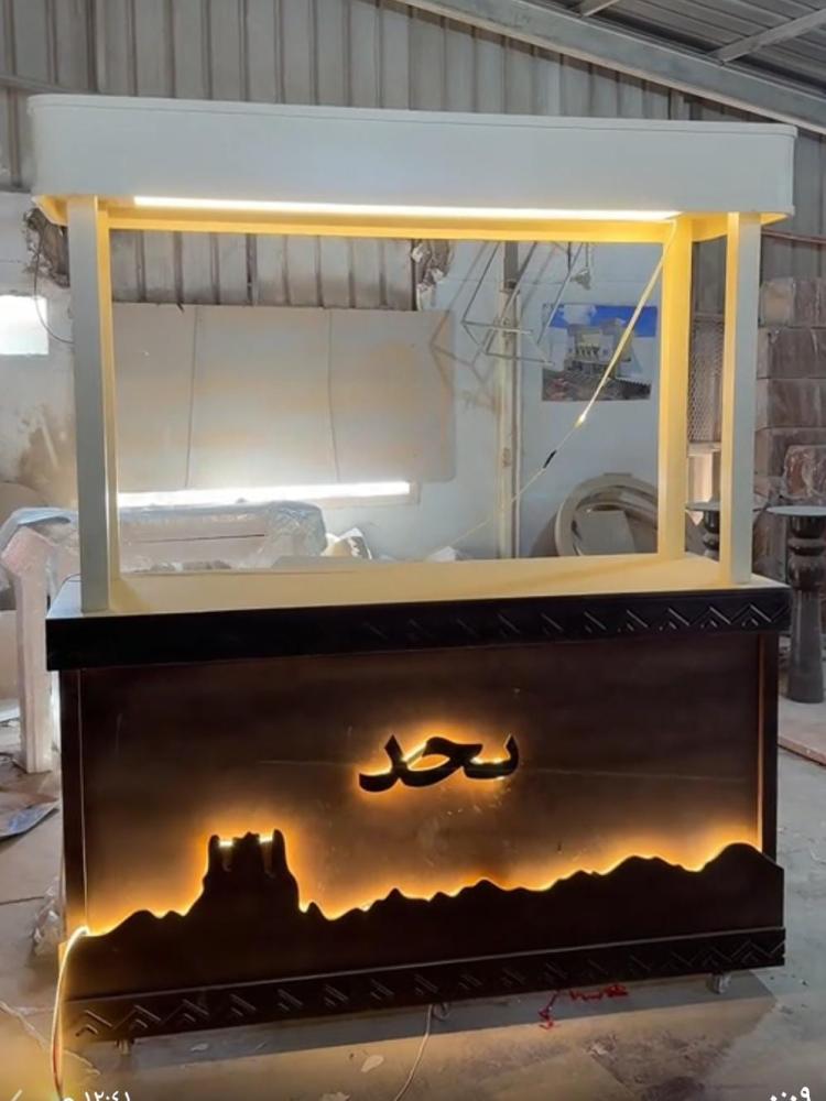 عربية كافي مع إضاءة – تصميم فاخر  * ، مصنوعة من الخشب الطبيعي ومطلية باللون الرمادي، بتصميم عصري يناسب المقاهي والمناسبات والفعاليات.  * مزودة بإضاءة جذابة تضيف لمسة فخامة  * مع إمكانية كتابة الأسماء أو الشعار حسب الطلب.  * المواصفات:  الطول: 140 سم  الار
