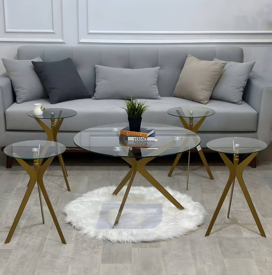 A set of hospitality tables with transparent glass and golden bases