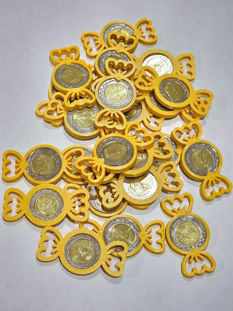 توزيعات ريالات المعدن شكل حلاوة