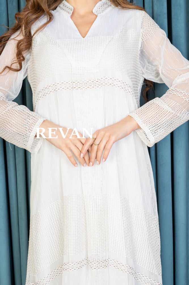 An elegant jalabiya with a soft design and sophisticated touches.