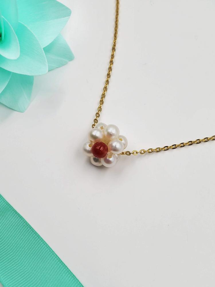 Silver charm with an elegant pendant of agricultural pearls.