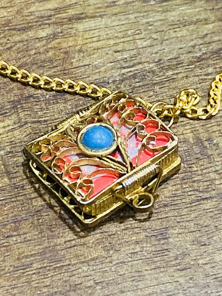 An old necklace with a very small Quran inside.