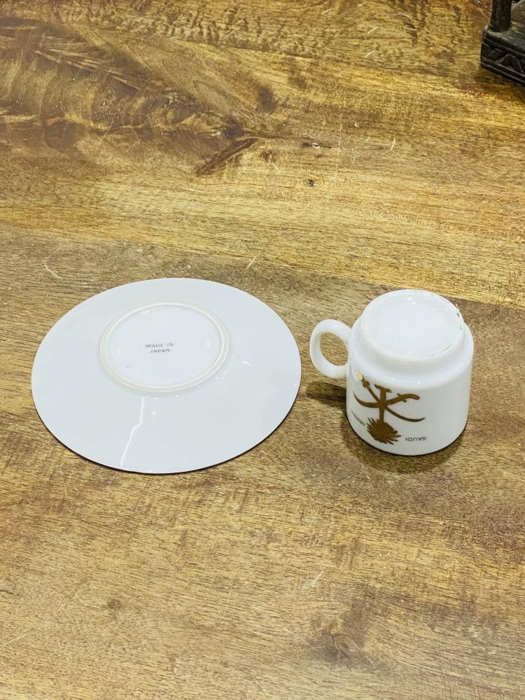 One of the very rare items; a 5 cm tall coffee cup made of pure porcelain with the country's emblem of two swords and a palm tree in gold color on the cup and saucer; expertly made, Japan craftsmanship (made specifically for one of the palaces) considered