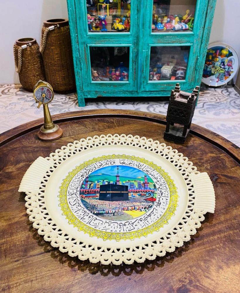 Among the rare items; a wall hanging or a tray made of sturdy plastic, equipped with an image of the Kaaba; an excellent storage container that has not been used.