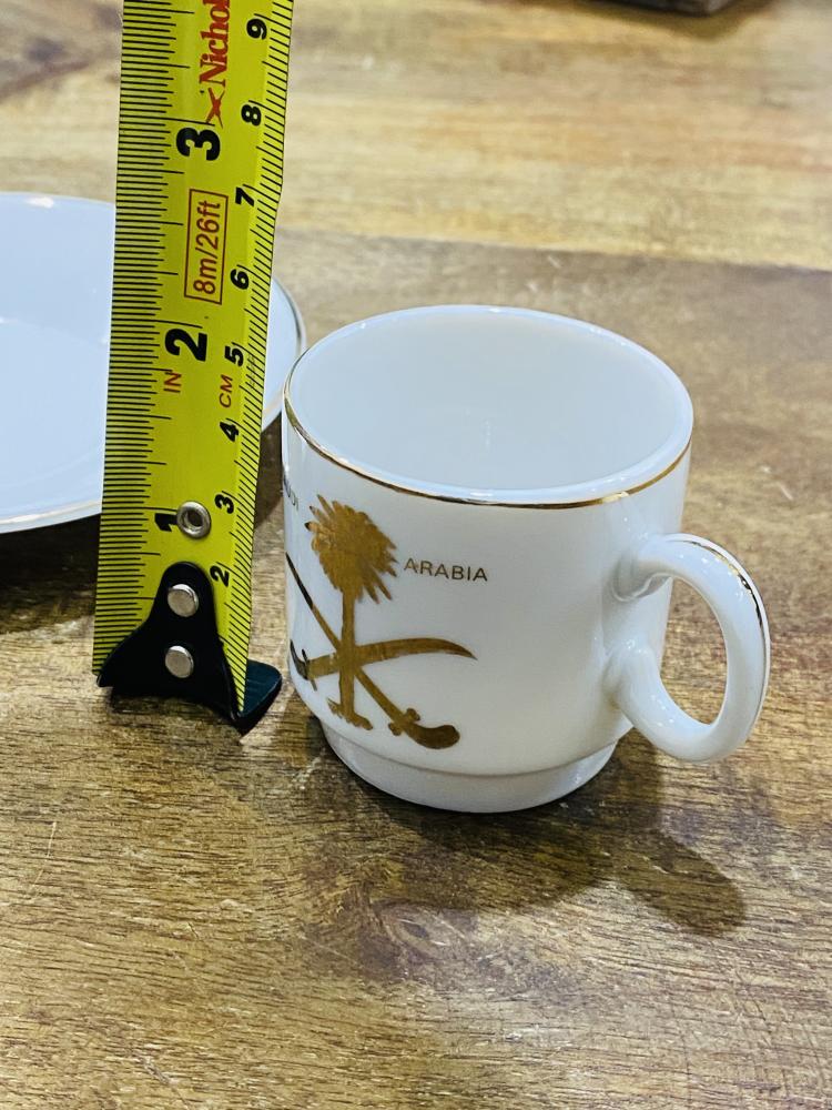 One of the very rare items; a 5 cm tall coffee cup made of pure porcelain with the country's emblem of two swords and a palm tree in gold color on the cup and saucer; expertly made, Japan craftsmanship (made specifically for one of the palaces) considered