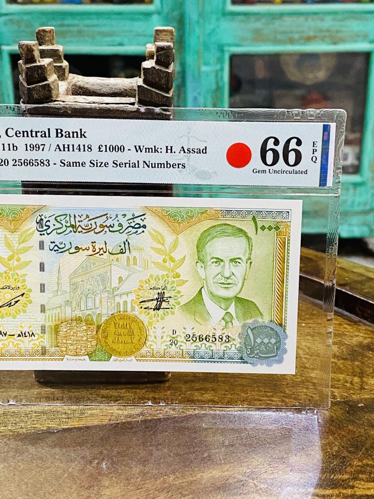 عملة سوريا فئة ١٠٠٠ ليرة عام ١٩٩٧م تقييم ٦٦ من شركة (PMG)