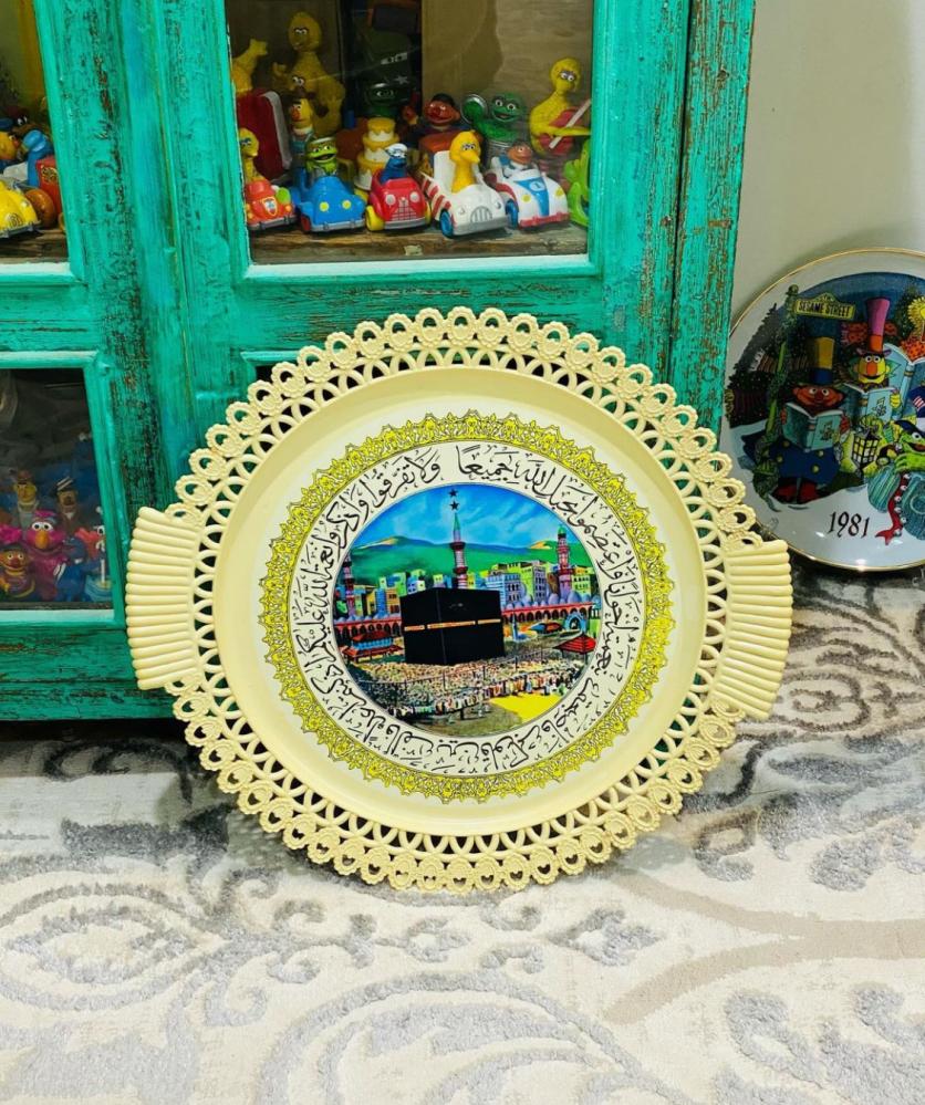 Among the rare items; a wall hanging or a tray made of sturdy plastic, equipped with an image of the Kaaba; an excellent storage container that has not been used.