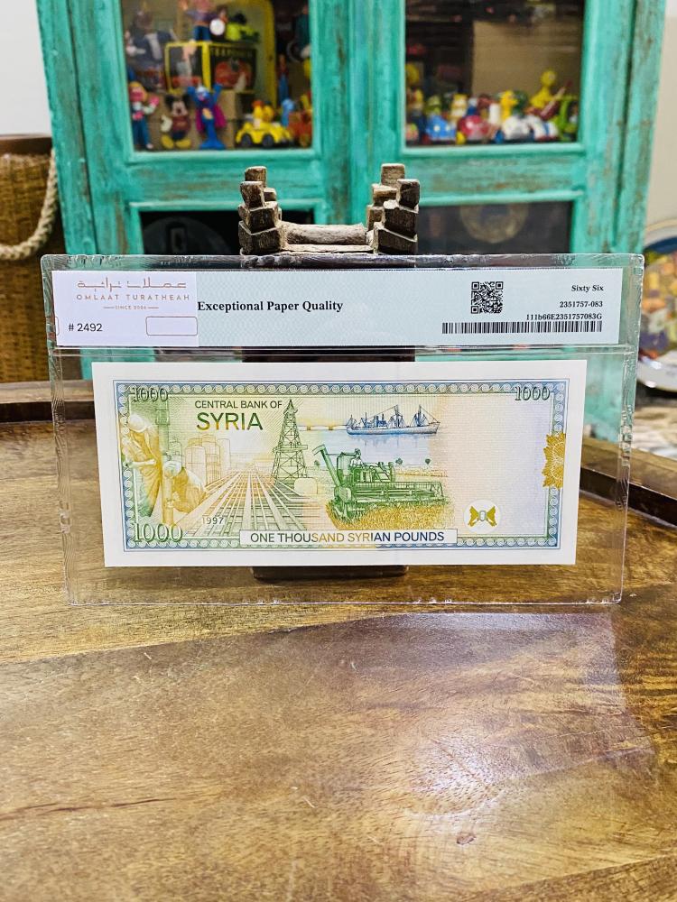 عملة سوريا فئة ١٠٠٠ ليرة عام ١٩٩٧م تقييم ٦٦ من شركة (PMG)